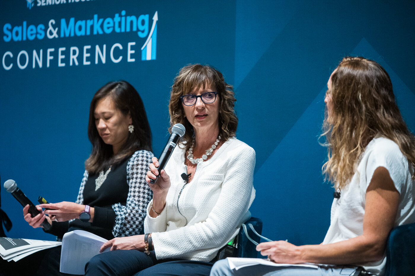 Healthcare professionals applauding during a conference session at an industry event